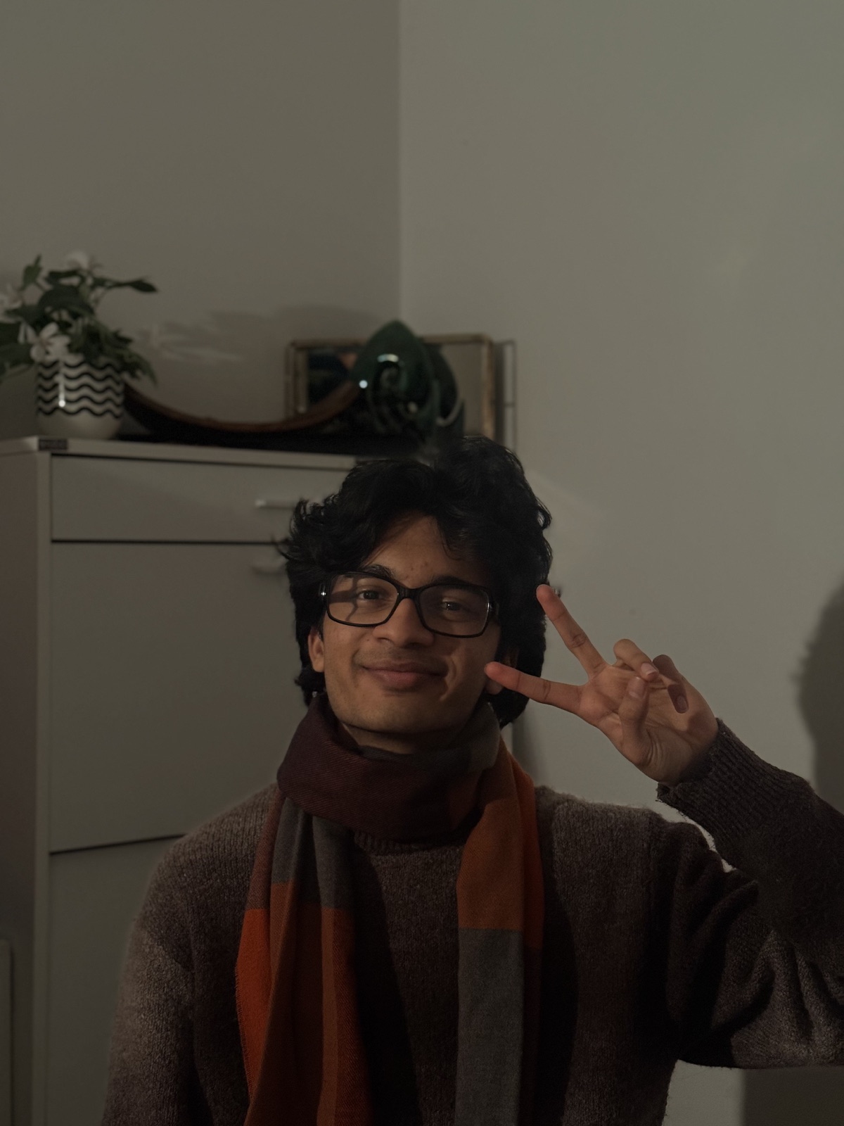 Vibbodh Somani smiling and holding up a peace sign.